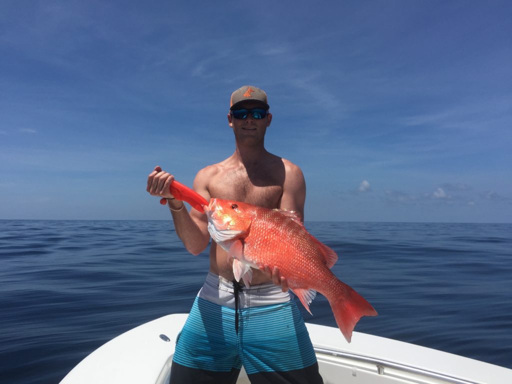 Fisherman holding a red snapper